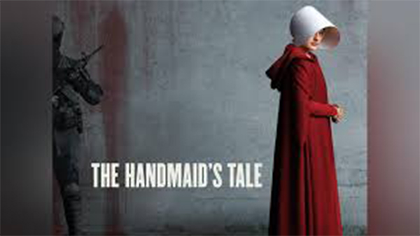 The Handmaid's Tale Television Show Promotional Image: A woman in a red cloak and white bonnet stands against a grey wall as the text THE HANDMAIDS TALE appears beside her, with a shadowy, armed figure partially visible in the background.