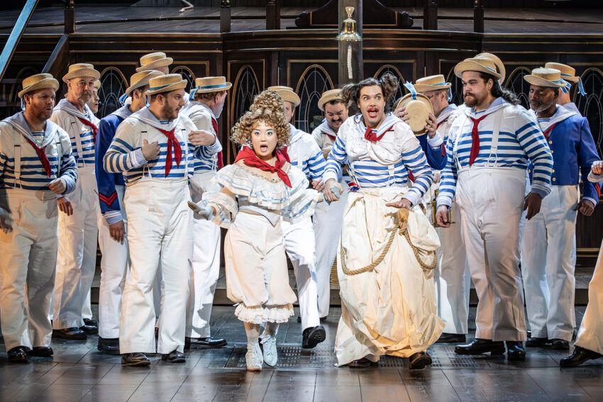 Henna Mun (centre) and Alaric Green (right) with the Cast of ENO’s HMS Pinafore 2025 © Craig Fuller 