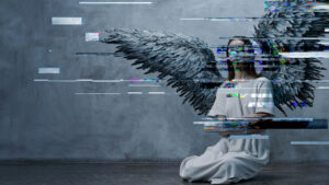 A woman in a white dress kneels on the floor with large, dark angel wings against a grey wall. Digital glitch effects obscure parts of her body and wings, evoking the haunting atmosphere of Du Yun and Royce Vavrek’s Angel’s Bone.
