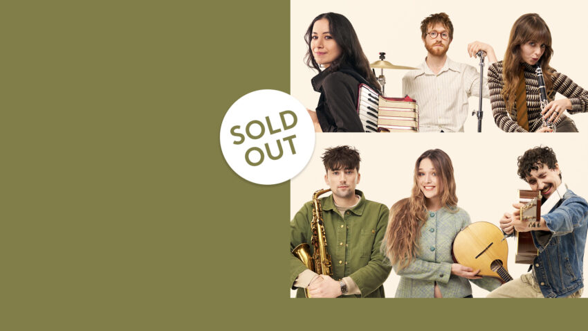 Six musicians from Black Country, New Road pose with instruments and books against a beige background. A SOLD OUT label overlays the image, which has a large olive green area on the left side, evoking the atmosphere of their acclaimed Sessions at venues like the London Coliseum.