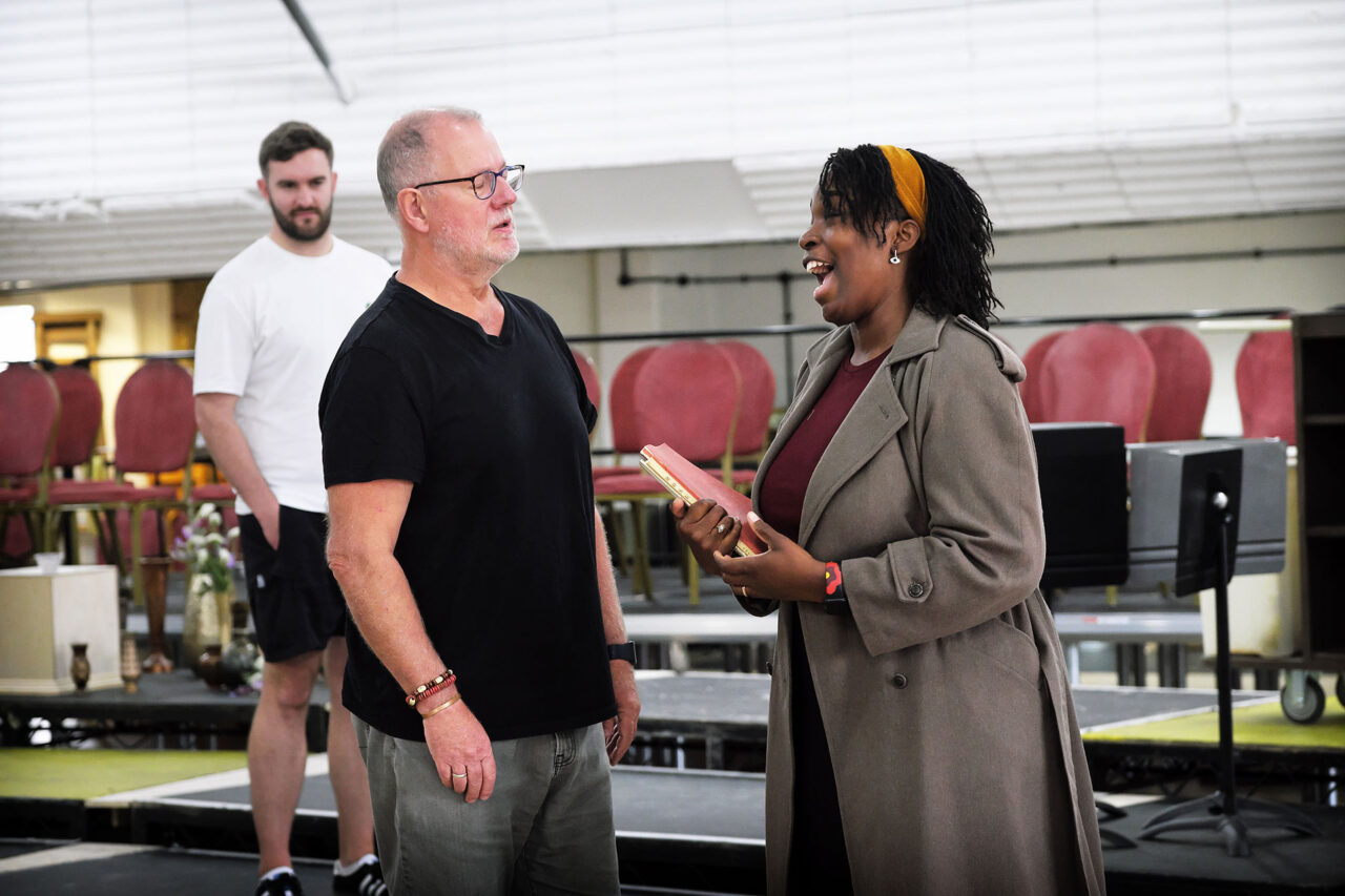 Steffan Lloyd Owen who will play Sciaronne, Robert Hayward who will play the Sacristan, and Axelle Fanyo who will play Tosca in ENO's 2026 production: Rehearsal Images © Zoe Martin