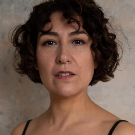 a woman with dark curly hair