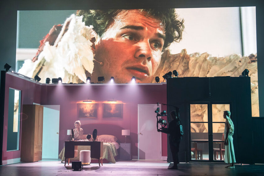 Matthew McKinney, Allison Cook, Onstage Camera Operator, Keith Pun, ENO’s Angel’s Bone 2026, London Coliseum © Tristram Kenton 